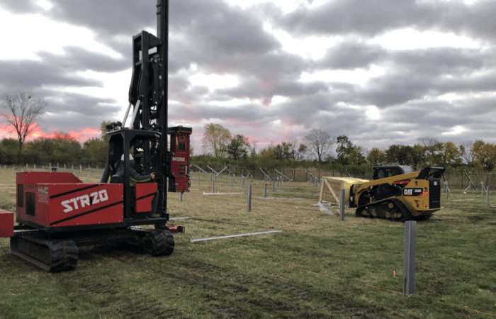 Nelnet Renewable Energy pile driver and bobcat machine. 