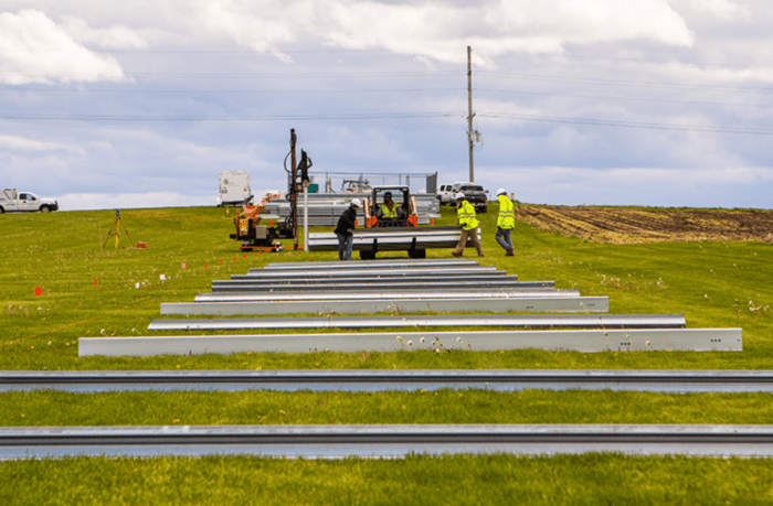 Laying out ground mount solar racking before it gets installed.