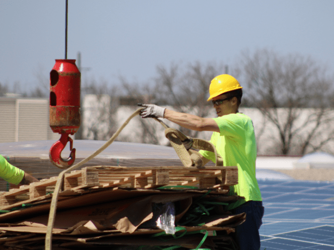 Solar installer cleaning up a work site.